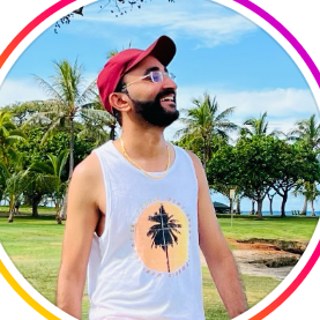 Amit Thakral outdoors, wearing a red cap